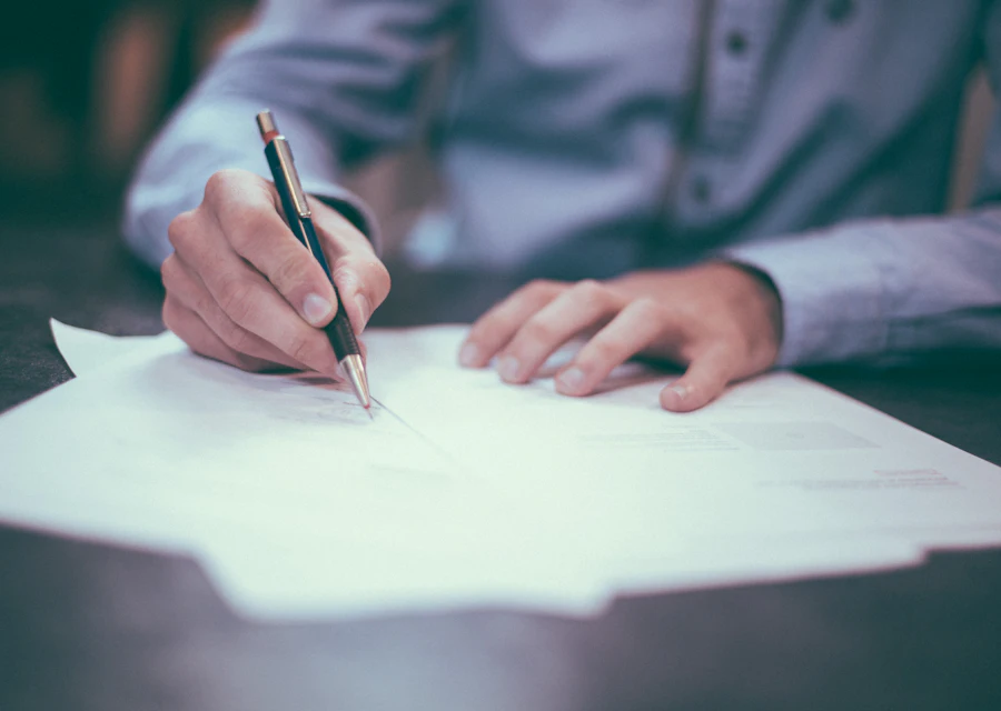 A company secretary checking board papers and filing documents