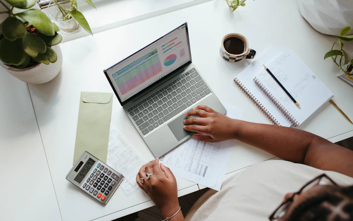 A laptop and calculator on a desk